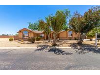 Charming single-story home featuring desert landscaping and mature trees for added curb appeal at 975 E Lincolnwood Cir, Casa Grande, AZ 85194