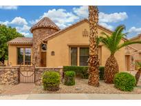 Charming home featuring a turret entrance, a stone accent wall, and desert landscaping at 1022 W Calypso Ct, Gilbert, AZ 85233
