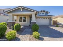 Charming single-story home featuring stone accents, manicured landscaping, and a welcoming paver driveway at 10609 E Durant Dr, Mesa, AZ 85212