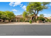 Charming home exterior with a tile roof, mature trees, and desert landscaping at 10892 E Gold Dust Ave, Scottsdale, AZ 85259