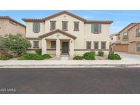 Beautiful two-story home featuring a charming facade, landscaped front yard and neutral color scheme at 16540 W Culver St, Goodyear, AZ 85338