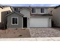 Charming two-story home featuring a two-car garage and neutral stucco finish at 18183 W Larkspur Dr, Goodyear, AZ 85338