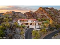 Luxury hillside home with red tile roof and long driveway winding through desert landscape at 1836 E Turquoise Ave, Phoenix, AZ 85020
