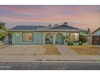 Charming single-story home featuring solar panels, an arched entryway and desert-friendly landscaping at 1838 E 2Nd Pl, Mesa, AZ 85203