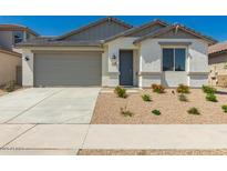 Charming single-story home with well-maintained landscaping and neutral-colored stucco at 18418 W Monte Lindo Ln, Surprise, AZ 85387