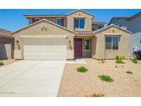Inviting two-story home with a two car garage, tile roof, and low maintenance front yard at 18456 W Monte Lindo Ln, Surprise, AZ 85387