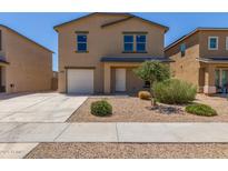 Two-story home featuring neutral paint, a driveway, and a low maintenance gravel yard at 255 W Dewey Ave, Coolidge, AZ 85128