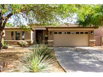 Charming single-story home featuring a two-car garage, desert landscaping, and a covered entryway at 3387 E Bluejay Dr, Chandler, AZ 85286