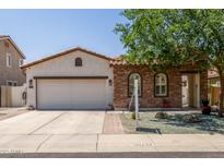 Charming single-story home with stucco and stone accents, tile roof, and a well-manicured front yard at 36197 W Cartegna Ln, Maricopa, AZ 85138