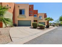 A modern townhome featuring a private drive, front yard landscaping, and a one car garage at 7601 E Roosevelt St # 1007, Scottsdale, AZ 85257