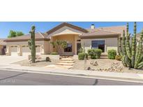Inviting single-story home featuring desert landscaping with cacti, stone pathway, and beige stucco exterior at 9548 E Grandview St, Mesa, AZ 85207