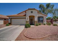 Charming single-story home with a well-maintained front yard and a two-car garage at 15902 W Hearn Rd, Surprise, AZ 85379