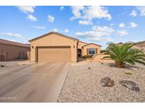 Charming single-story home featuring a well-maintained front yard with desert landscaping and an attached two-car garage at 16444 W Chuparosa Ln, Surprise, AZ 85387