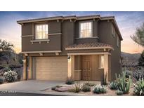 A charming two-story home featuring desert landscaping, a two-car garage and an inviting entryway at 17601 W Luke Ave, Litchfield Park, AZ 85340