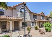 Charming townhome with a well-maintained front yard and covered entry, offering curb appeal at 1961 N Hartford St # 1055, Chandler, AZ 85225