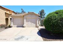 Charming home featuring a two-car garage, desert landscaping, and a well-maintained front yard at 3122 E Kristal Way, Phoenix, AZ 85050