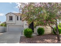 Charming two-story home featuring a well-manicured lawn and a welcoming entrance, enhancing its curb appeal at 4135 E Waterman Ct, Gilbert, AZ 85297