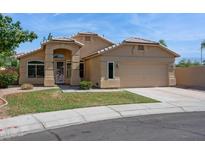 Charming single-story home with a two-car garage and a well-maintained lawn at 5010 W Ivanhoe St, Chandler, AZ 85226