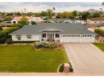 Charming home featuring a well-manicured lawn, three-car garage, and inviting curb appeal at 6311 E Calle Rosa --, Scottsdale, AZ 85251