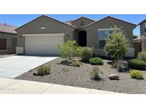 Charming single-story home with a well-maintained front yard and a two-car garage at 10743 W Bronco Trl, Peoria, AZ 85383