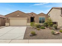 Charming single-story home featuring a desert landscaped front yard and an attached two car garage at 10743 W Bronco Trl, Peoria, AZ 85383