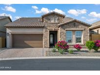 Charming single-story home featuring a manicured front yard and brick-paved driveway leading to a two-car garage at 1915 N Bernard Cir, Mesa, AZ 85207