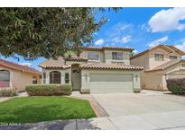 Charming two-story home featuring a well-maintained front yard and a welcoming facade at 20734 N 38Th St, Phoenix, AZ 85050