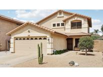 Charming two-story home with a tile roof, desert landscaping, and a two-car garage at 2306 E Parkside Ln, Phoenix, AZ 85024