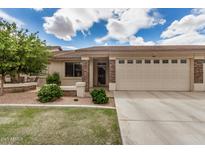 Charming single-story home with a well-manicured lawn, stone accents, and a two-car garage in a sunny setting at 2662 S Springwood Blvd # 462, Mesa, AZ 85209