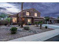 Two-story home featuring rock landscaping, well-placed foliage, and a welcoming entryway, perfect for suburban living at 3488 N Lady Lake Ln, Casa Grande, AZ 85122