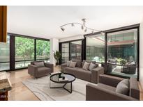 Bright living room featuring floor-to-ceiling windows, stylish furniture, and contemporary lighting at 4808 N 24Th St # 231, Phoenix, AZ 85016