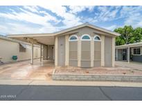 Inviting home featuring arched windows and a covered parking area providing both style and convenience at 5735 E Mcdowell Rd # 67, Mesa, AZ 85215