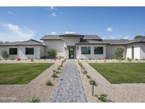 Stunning single-story home featuring a paved walkway, manicured landscaping and exterior stone accents at 6614 E North Ln, Paradise Valley, AZ 85253