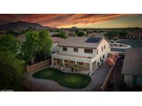 A backyard view featuring a custom-designed lawn and covered patio, perfect for outdoor living at 6623 S Classic Way, Gilbert, AZ 85298