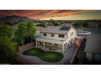 An aerial view reveals a well-maintained backyard with a unique kidney-shaped lawn and covered patio at 6623 S Classic Way, Gilbert, AZ 85298