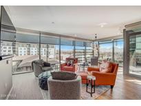 Bright living room with large windows providing stunning city views and hardwood flooring at 7120 E Kierland Blvd # 507, Scottsdale, AZ 85254