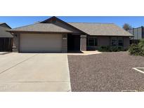 Charming single-story home with a well-maintained front yard and a two-car garage at 7402 W Corrine Dr, Peoria, AZ 85381