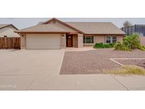 Charming single-story home with a two-car garage and low maintenance desert landscaping at 7402 W Corrine Dr, Peoria, AZ 85381