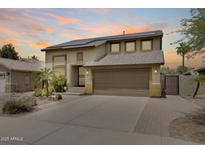 A well-maintained two-story home featuring desert landscaping, a spacious driveway, and a two-car garage at 7624 E Plata Ave, Mesa, AZ 85212