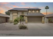 Two-story home featuring desert landscaping, a two-car garage, and solar panels at 7624 E Plata Ave, Mesa, AZ 85212