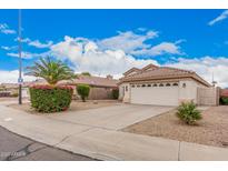 Charming single-Gathering home featuring a two-car garage, desert landscaping, and a tile roof at 1019 N Monterey St, Gilbert, AZ 85233