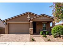 Inviting single-Gathering home featuring a two-car garage, low maintenance landscaping, and covered porch at 10307 E Tiburon Ave, Mesa, AZ 85212