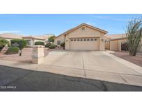 Charming single-story home with a two-car garage and well-maintained desert landscaping in front at 10613 E Nacoma Dr, Sun Lakes, AZ 85248