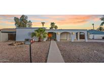 Charming home with an arched porchway, desert landscaping, and delightful curb appeal at 10619 N 38Th Ave, Phoenix, AZ 85029