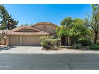 Charming single-story home with desert landscaping, tile roof, and a spacious three-car garage at 1243 W Sherri Dr, Gilbert, AZ 85233