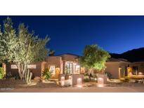 Inviting desert home with beautiful landscaping and nighttime illumination enhancing curb appeal at 15135 E Sundown Dr, Fountain Hills, AZ 85268