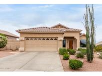 Charming single-story home featuring a well-manicured front yard with desert landscaping and a two-car garage at 17132 E Hillcrest Dr, Fountain Hills, AZ 85268