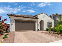 Charming single-story home featuring a two-car garage and a well-maintained, drought-resistant landscaped front yard at 18422 W Clinton St, Surprise, AZ 85388