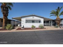 Charming single-story home featuring a covered carport and well-maintained desert landscaping at 205 S Higley Rd # 286, Mesa, AZ 85206
