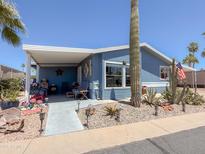 Charming single-story home with lovely desert landscaping and a cozy covered porch at 3104 E Broadway Rd # 212, Mesa, AZ 85204